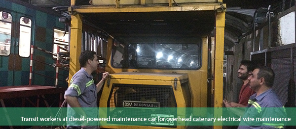 Transit workers at diesel-powered maintenance car for overhead catenary electrical wire maintenance